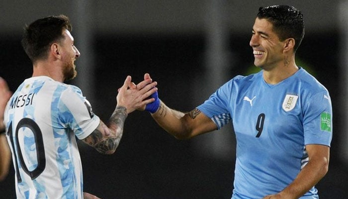 Lionel Messi (left) greets Luis Suarez before the start of the South American qualification match for the FIFA World Cup Qatar 2022, at the Monumental stadium in Buenos Aires on October 10, 2021. — AFP