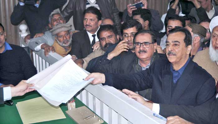 Senior Vice Chairman PPP, Syed Yousaf Raza Gillani is submitting his nomination papers with his supporters at the Commissioners office on December 22, 23. — APP