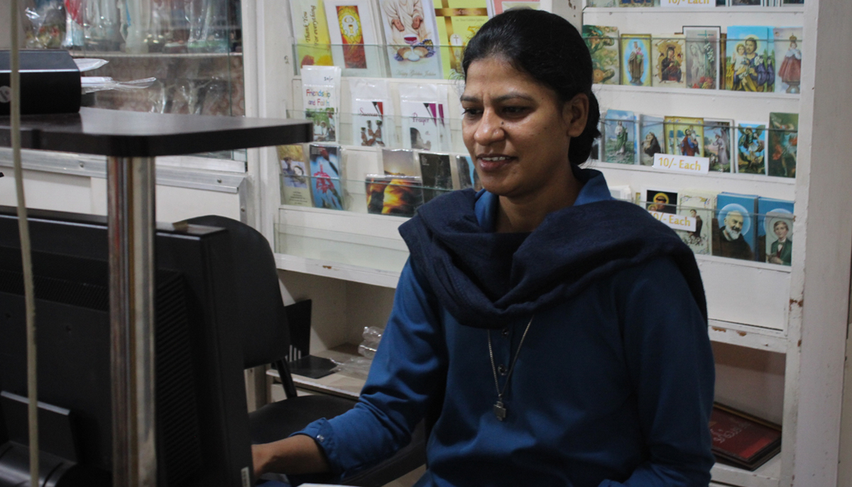 Sister Rukhsana Salamat is seen seated at the stores counter. — Photo by author