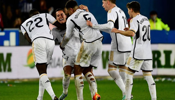 Real Madrids players celebrate at the end of the Spanish league football match between Deportivo Alaves and Real Madrid CF at the Mendizorroza stadium in Vitoria on December 21, 2023. — AFP