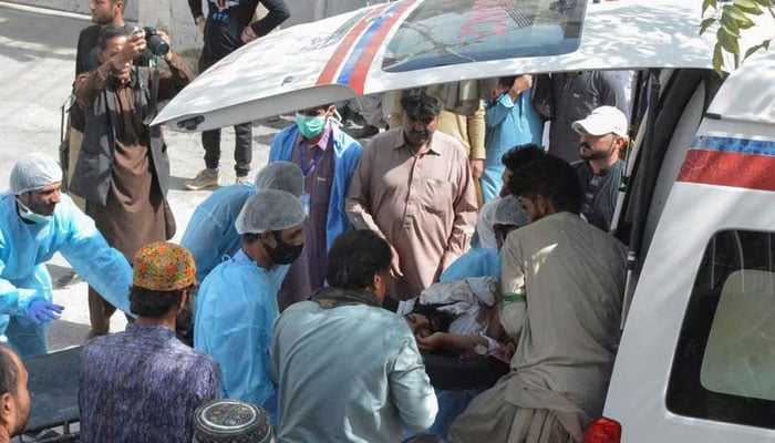 Men and paramedic staff transfer a man, who was injured in a blast in Mastung, from an ambulance outside hospital in Quetta, September 29, 2023. — Reuters