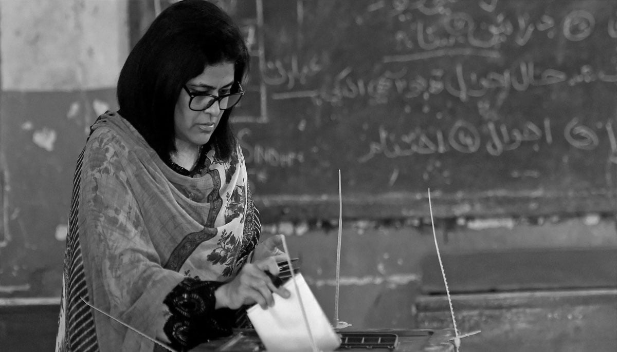 A female voter casts her ballot at a polling station during the by-election for National Assembly seats, in Karachi. — AFP/File