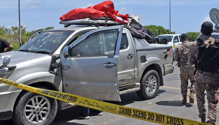 Pakistani security officials inspect the bullet-riddled vehicle after gunmen attacked the Defence Housing Authority area in Karachi on July 26, 2023. — Online