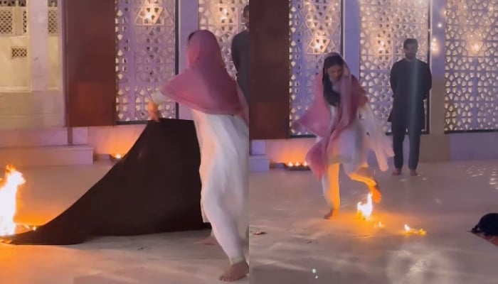Pakistani actor Ayeza Khan is seen putting of flames in this still taken from a video. — Instagram/@ayezakhan.ak