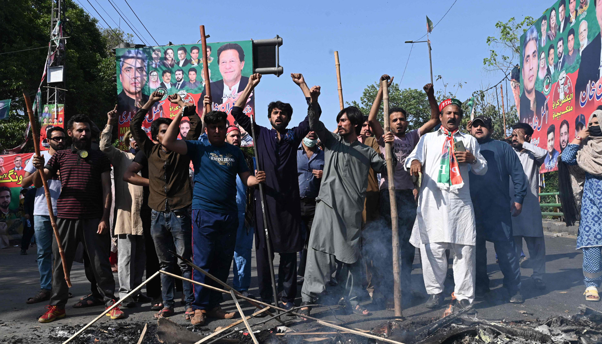 Pakistan Tehreek-e-Insaf party activists shout slogans during a protest against the arrest of their leader, Imran Khan, in Lahore on May 9, 2023. — AFP
