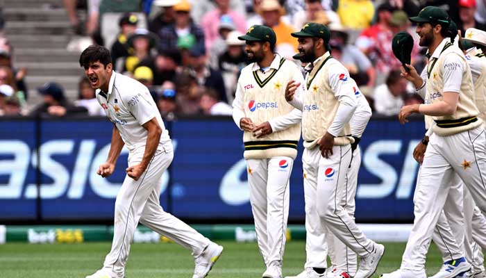 Pakistan bowler Mir Hamza (L) celebrates with teammates after dismissing Australian batsman Travis Head on the third day of the second cricket Test match between Australia and Pakistan at the Melbourne Cricket Ground (MCG) in Melbourne on December 28, 2023. — AFP