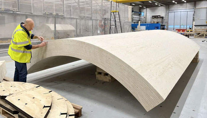 David Olivegren of Modvion inspects a modular section of the wooden turbine tower in the factory.—Modvion