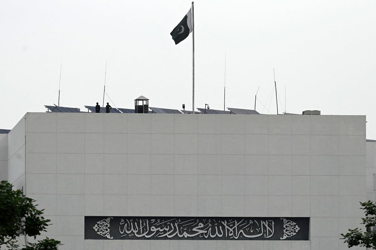 Security personnel stand guard on top of the parliament house building in Islamabad on August 9, 2023. — AFP