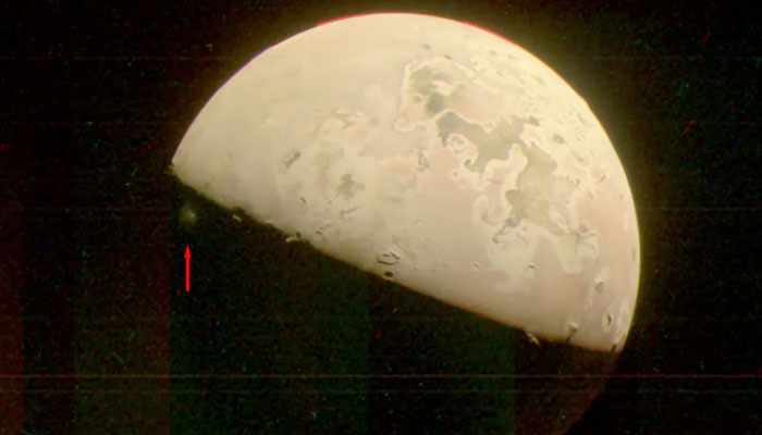 This JunoCam image of Jupiter’s moon Io captures a plume of material ejected from the (unseen) volcano Prometheus. Indicated by the red arrow, the plume is just visible in the darkness below the terminator (the line dividing day and night). The image was taken by Nasas Juno spacecraft on October 15.- Nasa