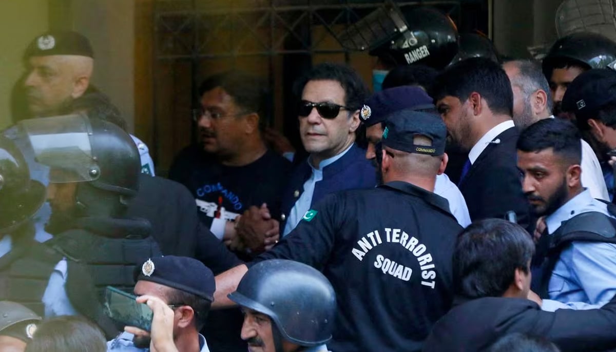 Security officers escort Pakistans former Prime Minister Imran Khan, as he appeared in Islamabad High Court, Islamabad, Pakistan May 12, 2023. — Reuters