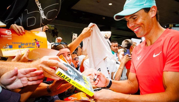 Spains Rafael Nadal signs autographs during a promotional event ahead of the Brisbane International. — AFP