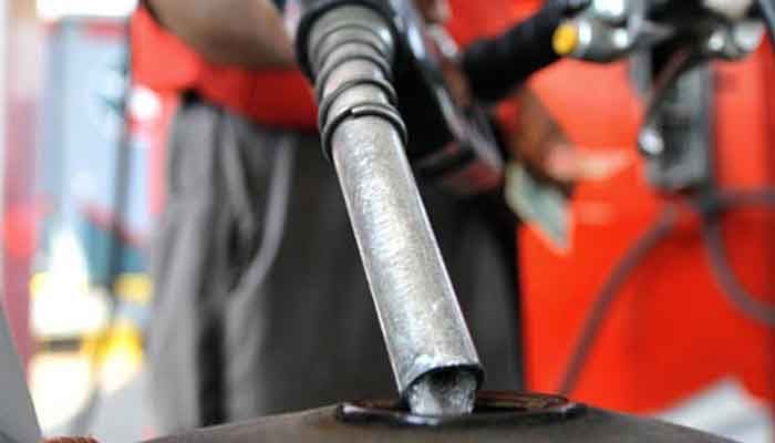 The picture shows a worker at a gas station fuelling a motorcycle tank. — APP/File