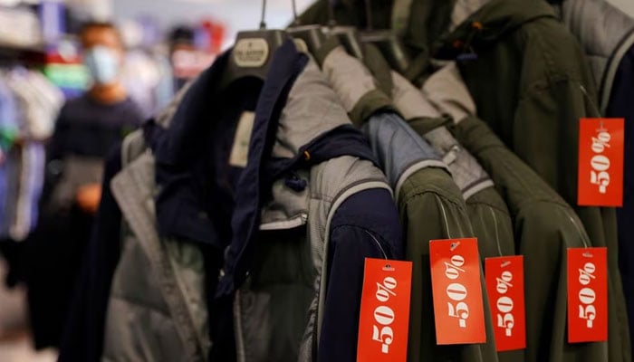 Clothes with discount signs are displayed at a shop in Cambrai on the first day of summer sales in France, June 30, 2021. — Reuters