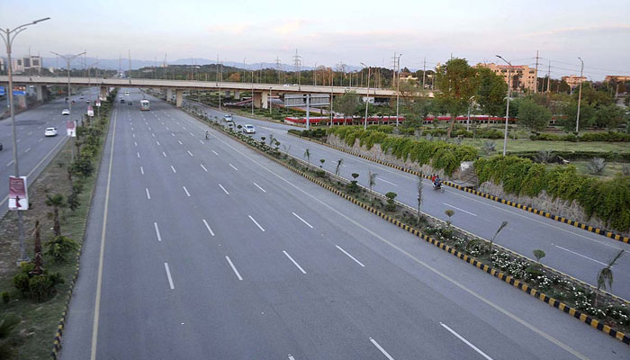 A deserted view of Srinagar Highway in Islamabad on April 21, 2023. — APP