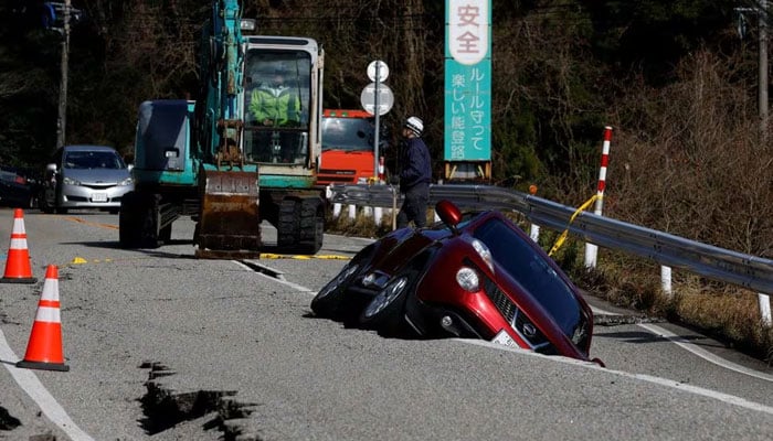 A view of a car stuck in a crack in the road, following an earthquake, near Ujima, Ishikawa prefecture, Japan, on January 2, 2024. – Reuters
