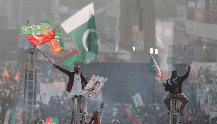 Supporters of the Pakistans former Prime Minister Imran Khan sit on scaffoldings to see their leader in Rawalpindi, Pakistan November 26, 2022. — Reuters