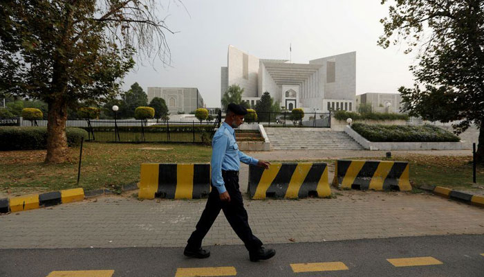 A policeman walks past the Supreme Court building in Islamabad, on October 31, 2018. — Reuters