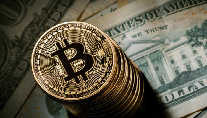 An image depicting Bitcoin kept over some cash. — AFP/File