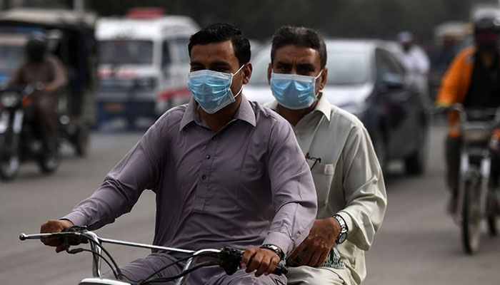 The picture shows two people riding a motorcycle. — AFP/File