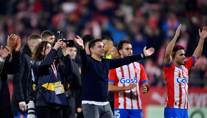 Gironas Spanish coach Michel (C) celebrates victory at the end of the thrilling 4-3 win over Atletico Madrid. — AFP