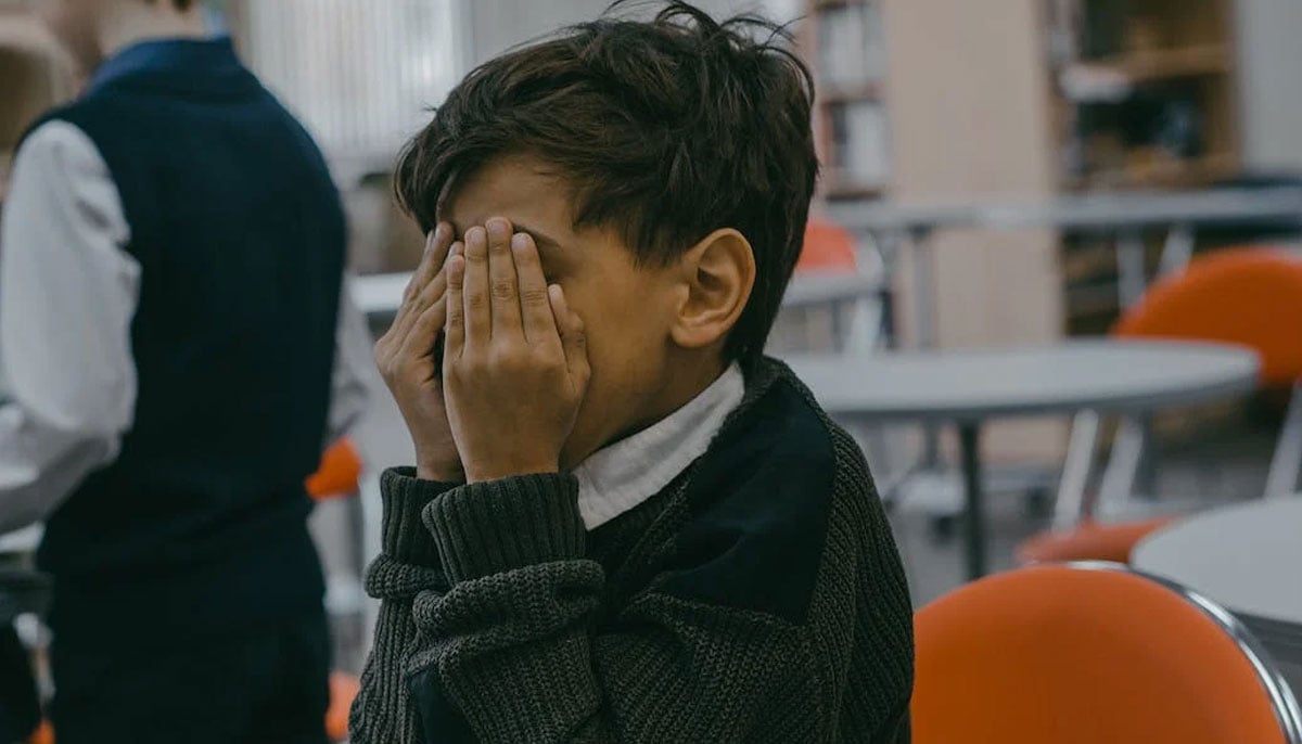 A representational image of a child covering his face. — Pexels