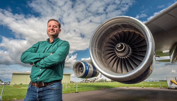 James Hygate, founder of Firefly Green Fuels, stands next to a passenger jets engine in this undated picture. — Firefly Green Fuels
