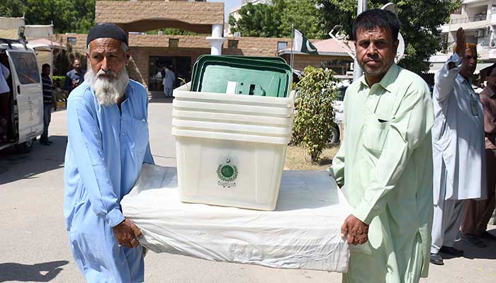 Polling agents collect electoral material ahead of a by-election in Karachi on October 15, 2022. — Online