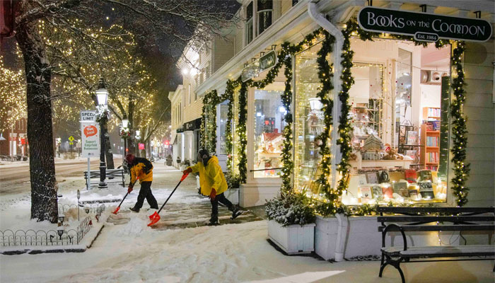 Workers shovel sidewalks as snow from the first winter storm of 2024, which is expected to dump heavy snow across the northeast United States, falls in Ridgefield, Connecticut, US on January 6, 2024. — Reuters