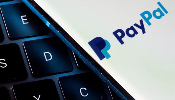 A smartphone with the PayPal logo is placed on a laptop in this illustration taken on July 14, 2021. — Reuters