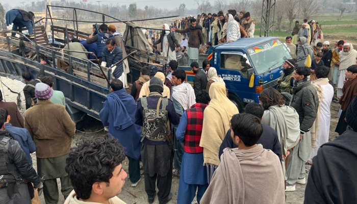 People gather around the police vehicle targeted in an explosion in Bajaur district on January 8, 2024. —Geo News
