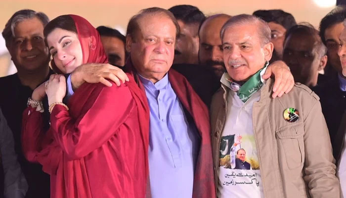 (L to R) PML-N leaders Maryam Nawaz, Nawaz Sharif and Shehbaz Sharif at the stage during a rally at Minar-e-Pakistan in Lahore, on October 21, 2023, in this still taken from a video. — X@pmln_org