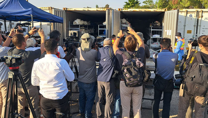 Reporters at the forensic centre of the Israeli army, fridge containers being opened for the camera. — Photo by Rov Vreeken