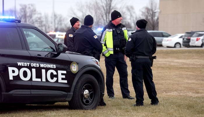 Police officers stand guard outside the Perry Middle School and High School complex following a school shooting on January 04, 2024, in Perry, Iowa. — AFP