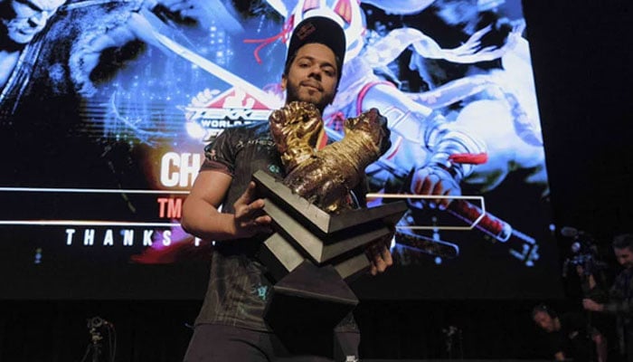 Arslan Ash poses with the trophy after winning the final. — X/@RedBullGaming