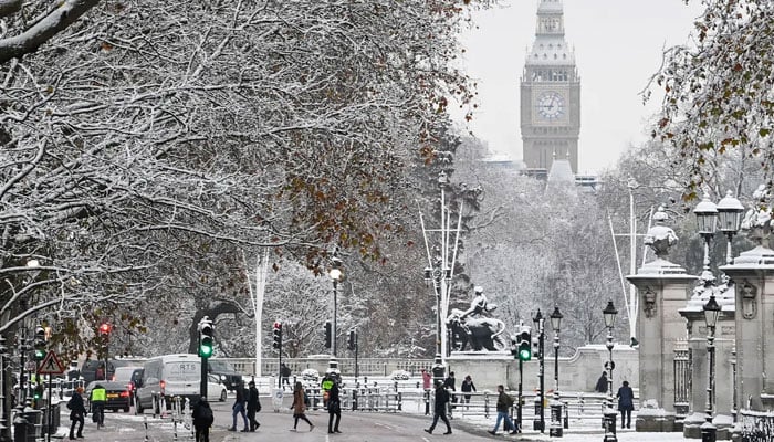 People walk on the street in front of The Elizabeth Tower, more commonly known as Big Ben, as cold weather continues, in London, Britain, December 12, 2022. —Reuters
