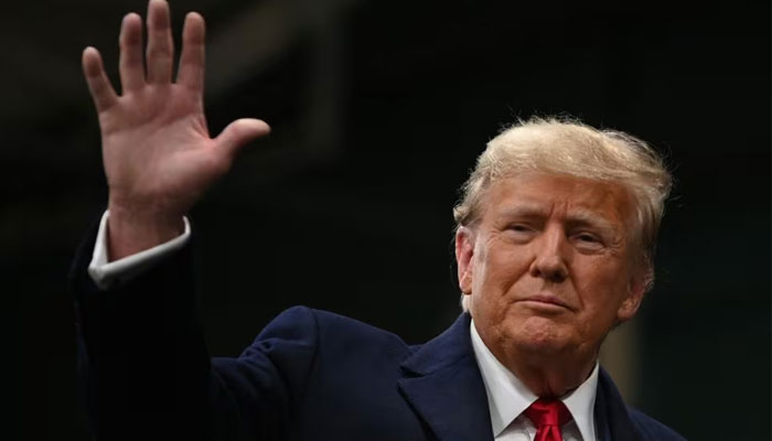 Republican presidential candidate and former US President Donald Trump waves as he visits a caucus site at Horizon Event Center in Clive, Iowa, US on January 15, 2024. — Reuters