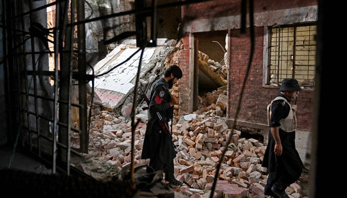 Security personnel inspect the site of a bomb blast in Bara province at Khyber Pakhtunkhwa district of Peshawar on July 20, 2023. — AFP