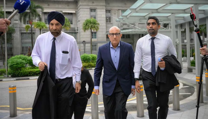 Subramaniam Iswaran, Singapores former transport minister, arrives at the State Courts with his legal team, including Senior Counsel Davinder Singh (L), in Singapore, January 18, 2024. — Reuters