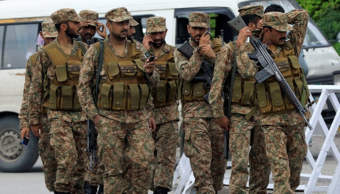 Army soldiers arrive at the premises of the distribution point where electoral workers gather to collect election materials, ahead of the general election in Rawalpindi, on July 24, 2018. — Reuters
