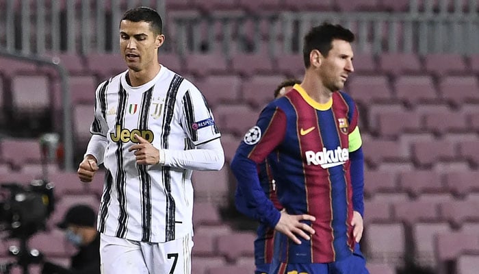 Cristiano Ronaldo and Lionel Messi gesture during the Champions League in 2020. — AFP/File
