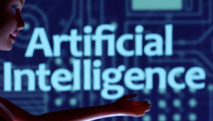The illustration shows AI bot in front of an Artificial Intelligence poster. — Reuters/File