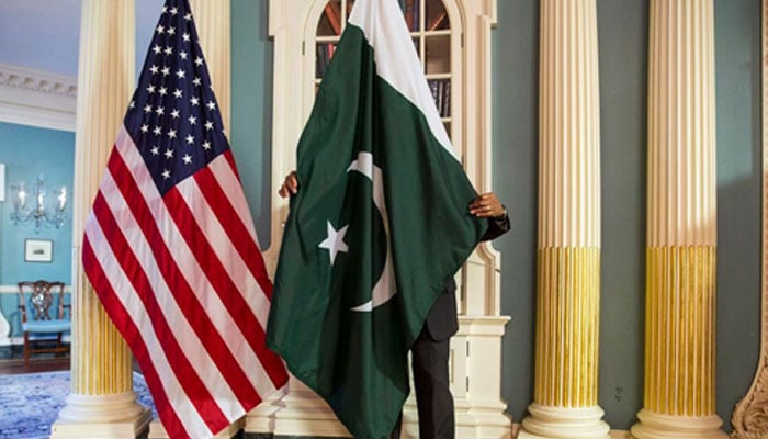 A State Department contractor adjusts a Pakistan national flag before a meeting between US secretary of state and Pakistans interior minister on the sidelines of the White House Summit on Countering Violent Extremism at the State Department in Washington February 19, 2015. — Reuters