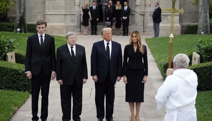 Former President Donald Trump, wife Melania, second right, with their son Barron and father-in-law Victor Knaves at the end of the funeral service for the former first lady's mother, Amalia Knaves, Thursday, Jan. 18, 2024, at Bethesda Church.  On the beach in Palm Beach.  - X/@ap