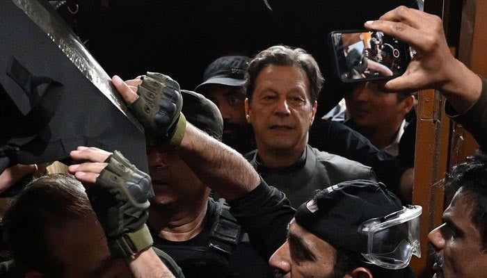 Former PTI chairman Imran Khan arriving at a court in this undated picture. — AFP