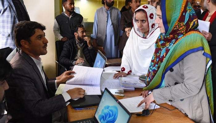 Women candidates submit their nomination papers ahead of the upcoming 2024 general elections, at the deputy commissioner office in Quetta on December 22, 2023. — AFP
