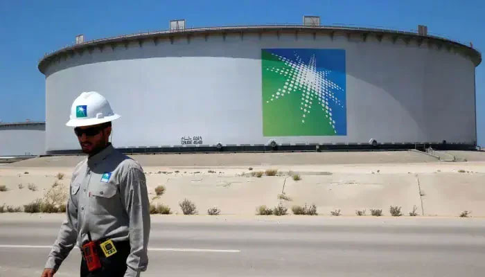 An Aramco employee walks near an oil tank at a Saudi Aramco oil refinery and oil terminal in Saudi Arabia. — Reuters/File