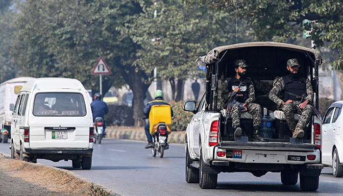 Paramilitary personnel patrolling a street ride a vehicle in Islamabad on January 22, 2024. — AFP