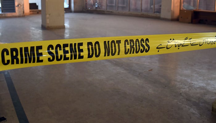 A crime scene tape can be seen at the site of an incident in Karachi, on February 18, 2023. — Online