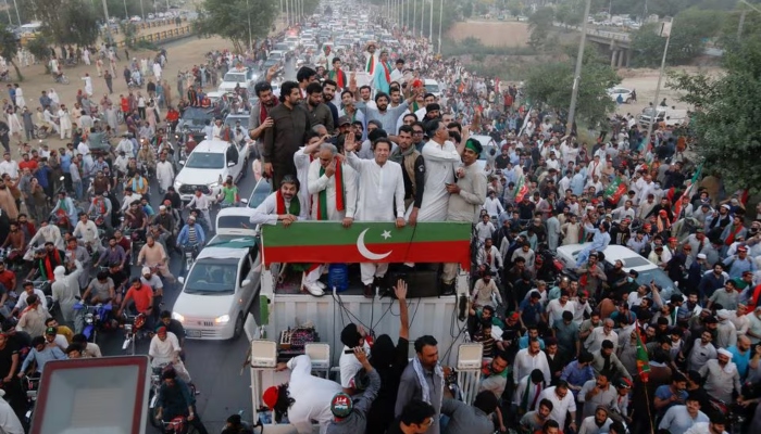 Incarcerated former prime minister Imran Khan gestures as he travels on a vehicle to lead a protest march in Islamabad on May 26, 2022. —Reuters