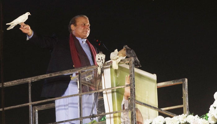 Pakistans former Prime Minister Nawaz Sharif prepares to release a pigeon in front of supporters in Lahore, Pakistan, October 21, 2023. — Reuters